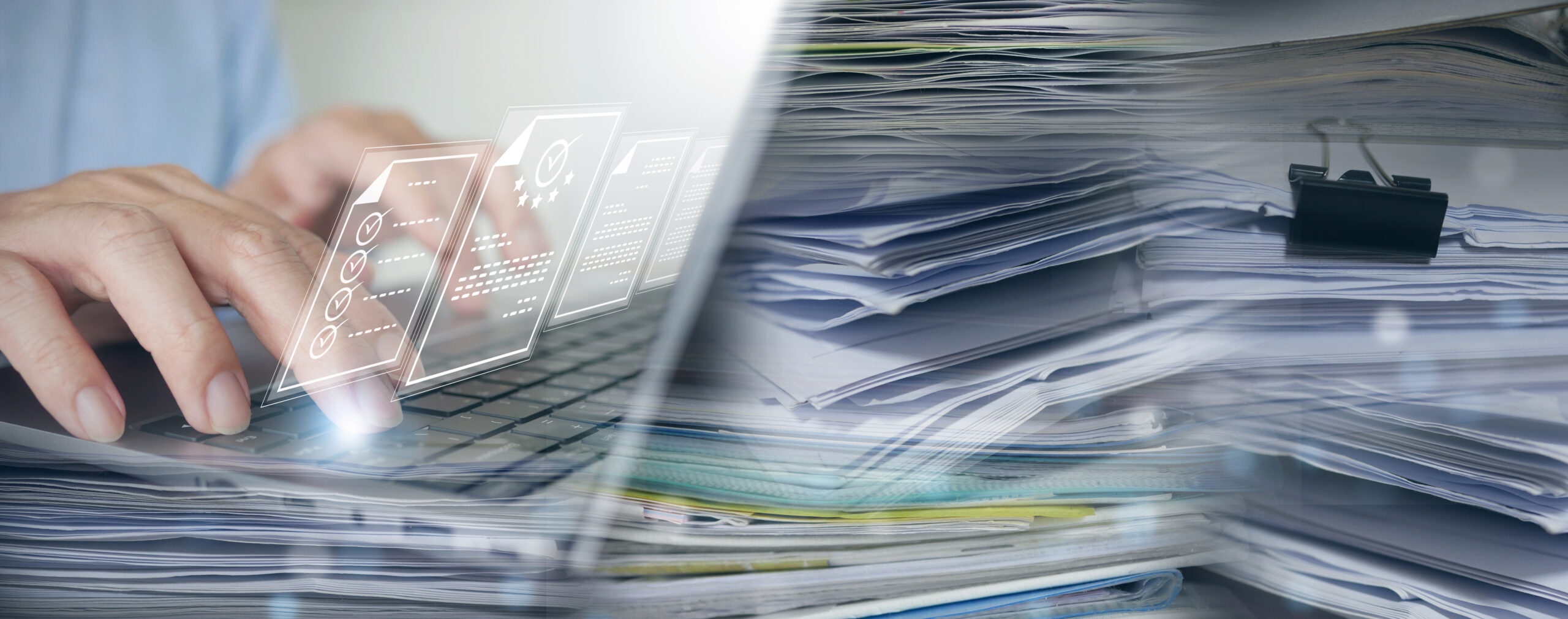 Person typing on a laptop with a holographic interface displaying documents and checklists, alongside a stack of paper documents. Document scanning for digital transformation and organization.