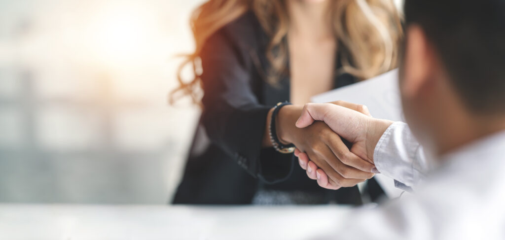 Close-up of a professional handshake symbolizing partnership and trust, highlighting the value of collaborating with a Managed Service Provider.